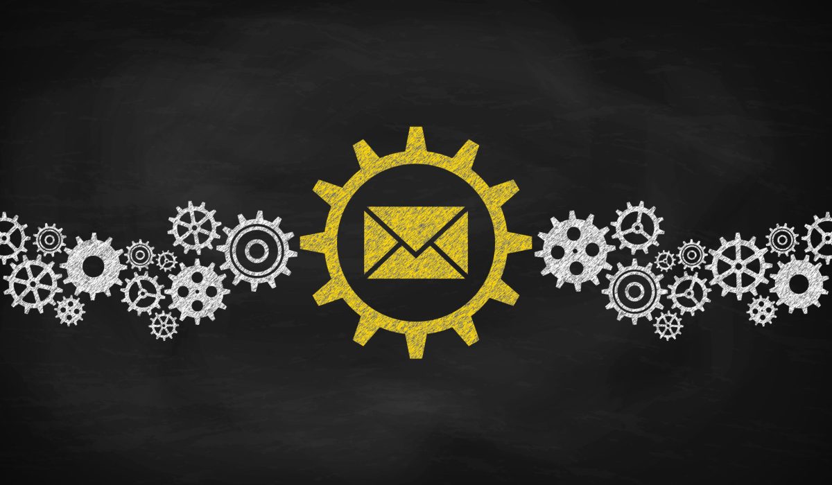 Cogwheels Concept With Envelope sign. Chalk on the blackboard.